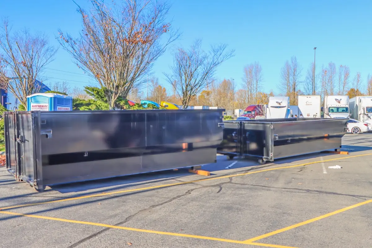 Professional dumpster rental service with roll-off container on residential driveway in Liberty Triangle